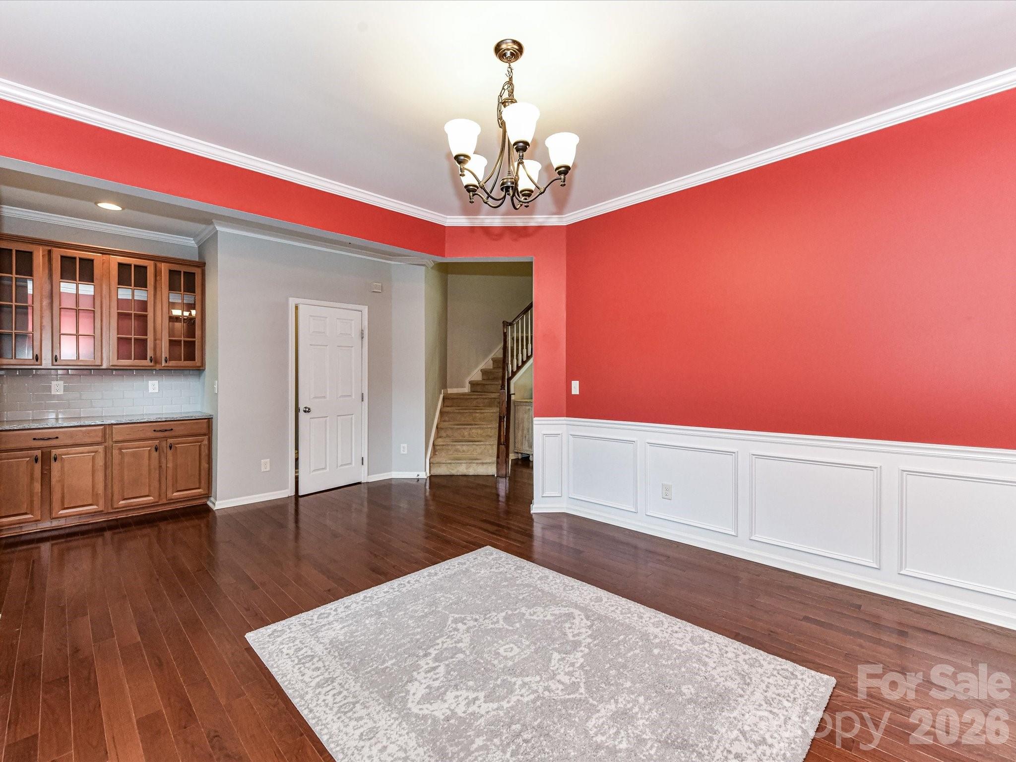 756 Naramore Street Davidson, NC 28036 - Photo 12 of 44 a room with wooden floor and chandelier