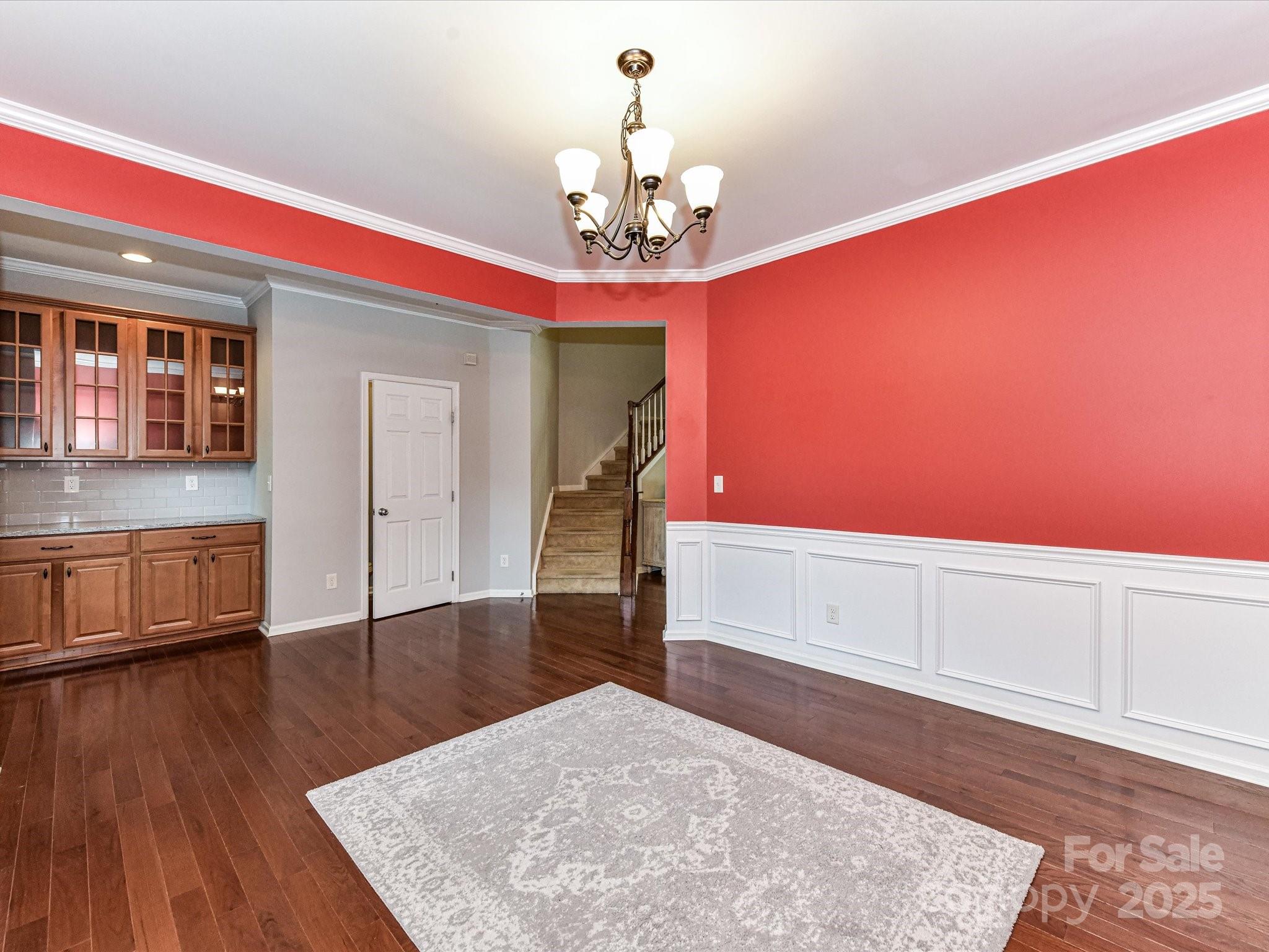 756 Naramore Street Davidson, NC 28036 - Photo 13 of 46 a room with wooden floor and chandelier