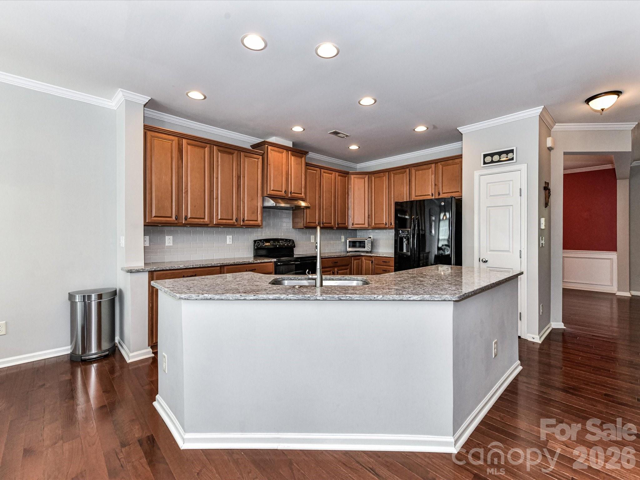 756 Naramore Street Davidson, NC 28036 - Photo 18 of 44 a kitchen with stainless steel appliances granite countertop a stove top oven a sink and a refrigerator