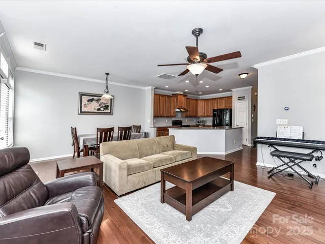 a kitchen with stainless steel appliances granite countertop a refrigerator a stove and a sink