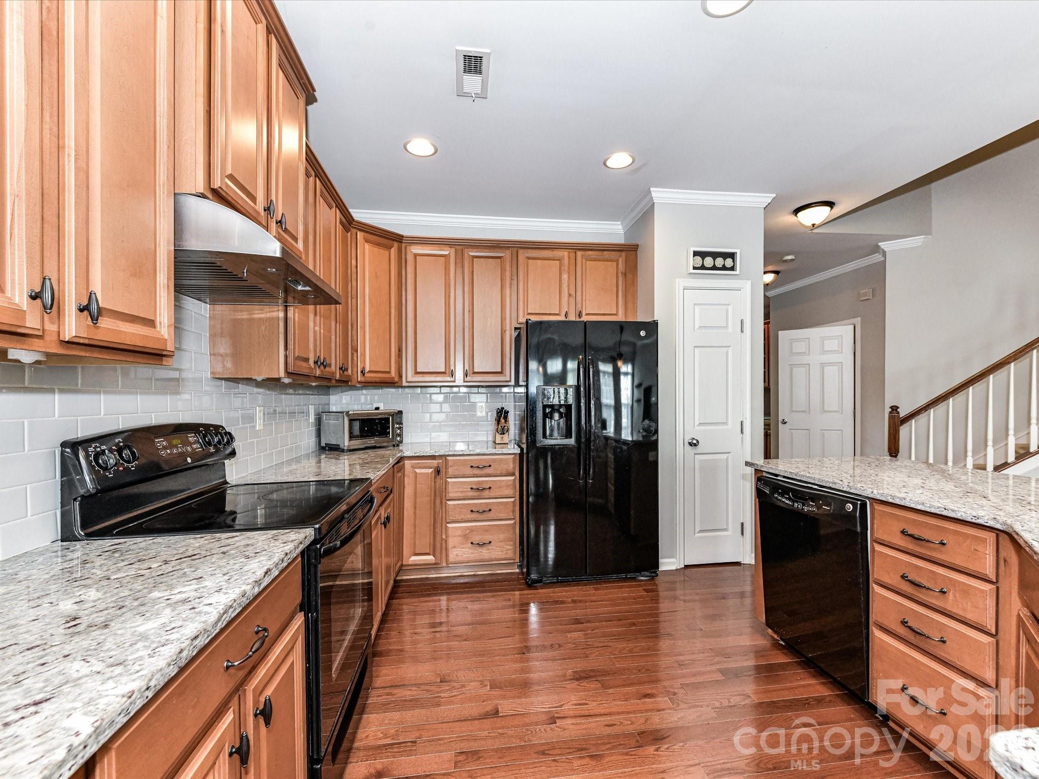 756 Naramore Street Davidson, NC 28036 - Photo 19 of 44 a kitchen with stainless steel appliances granite countertop a refrigerator a stove and a sink