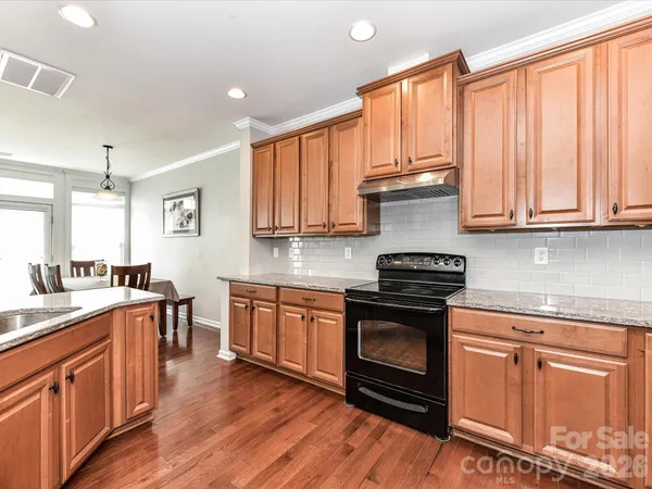 a stove top oven sitting inside of a kitchen