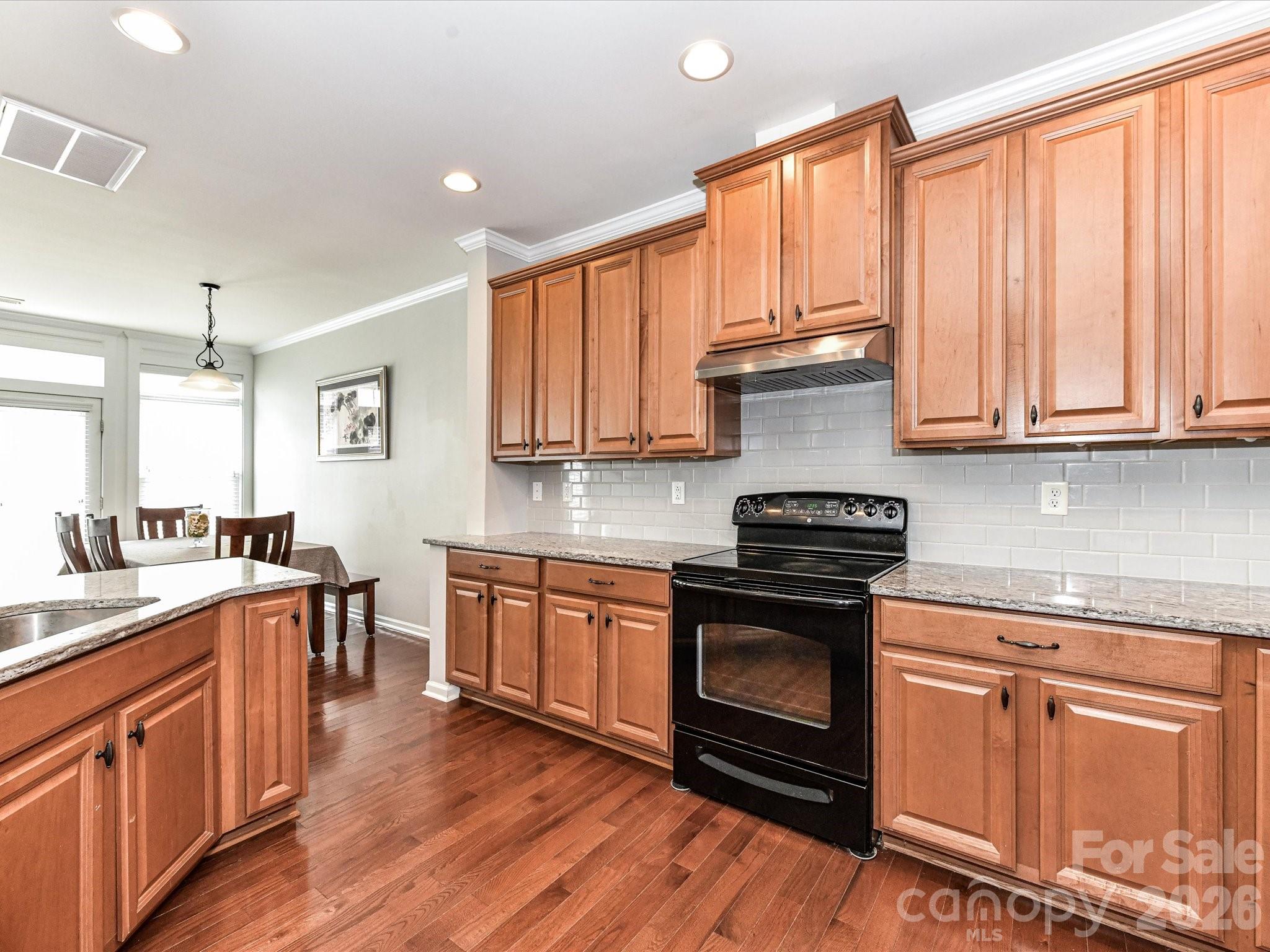 756 Naramore Street Davidson, NC 28036 - Photo 20 of 44 a kitchen with stainless steel appliances granite countertop a stove and cabinets