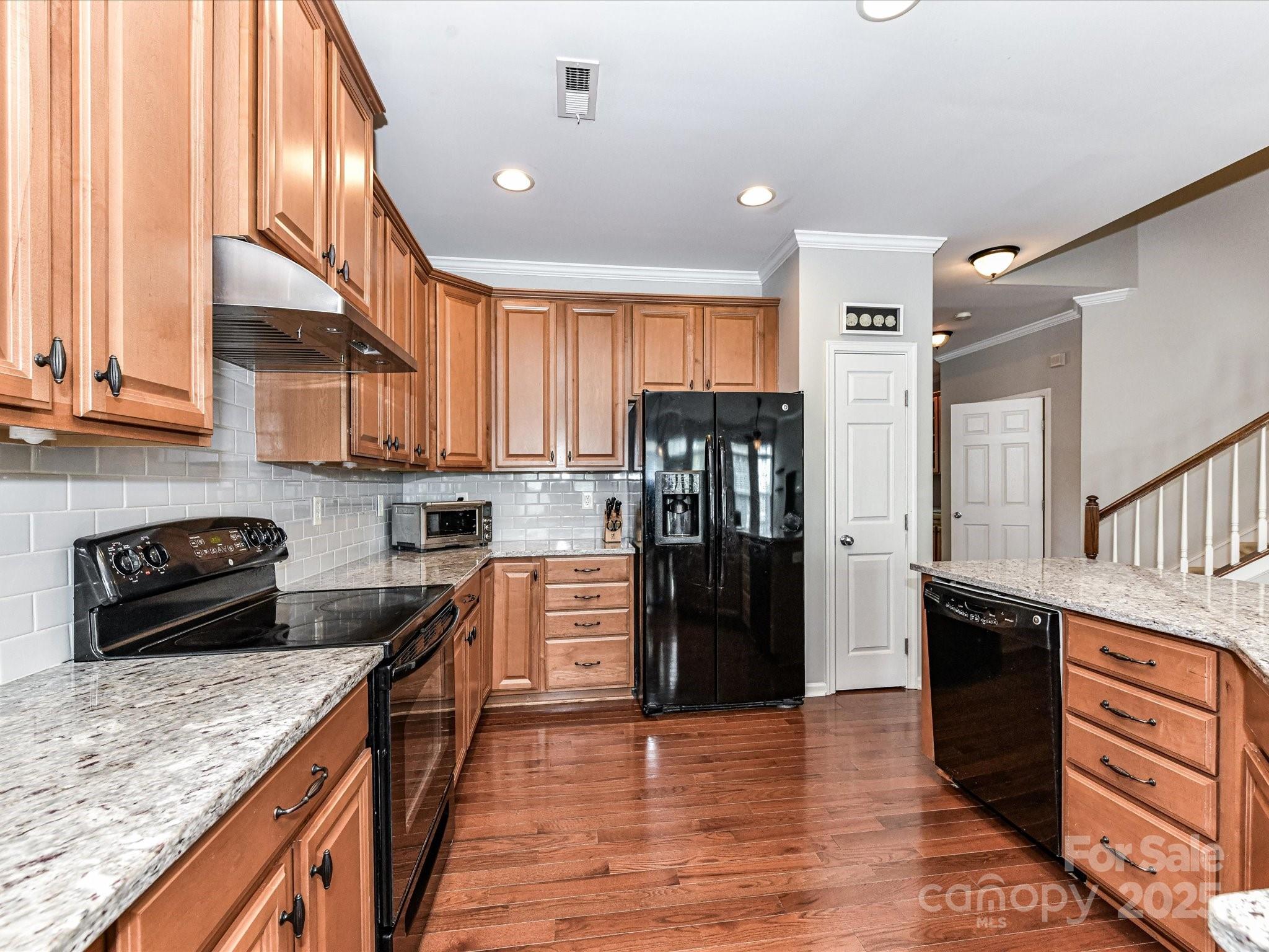 756 Naramore Street Davidson, NC 28036 - Photo 20 of 46 a kitchen with stainless steel appliances granite countertop a refrigerator a stove and a sink