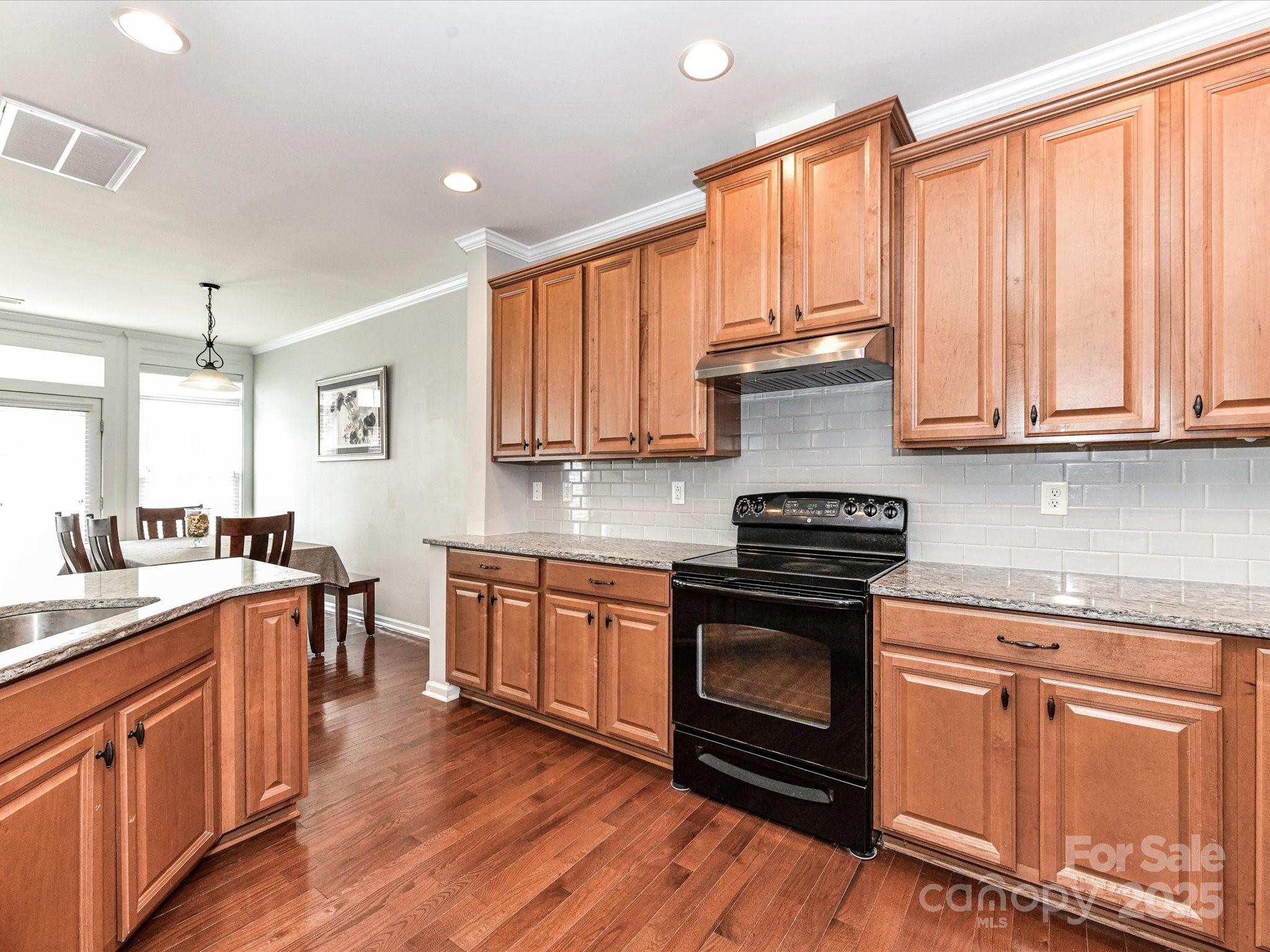 756 Naramore Street Davidson, NC 28036 - Photo 21 of 46 a kitchen with stainless steel appliances granite countertop a stove and cabinets