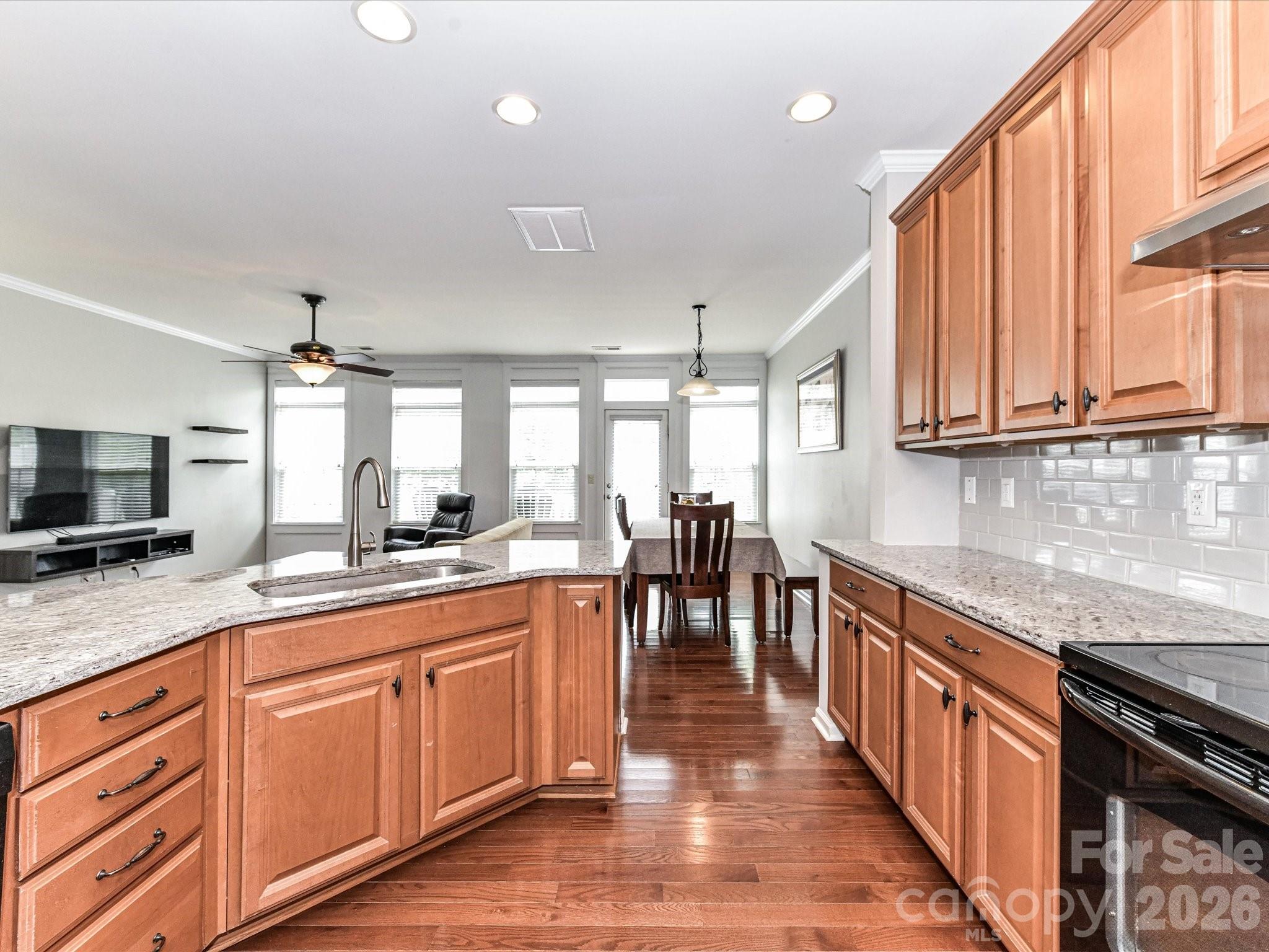 756 Naramore Street Davidson, NC 28036 - Photo 21 of 44 a kitchen with granite countertop lots of counter top space and stainless steel appliances