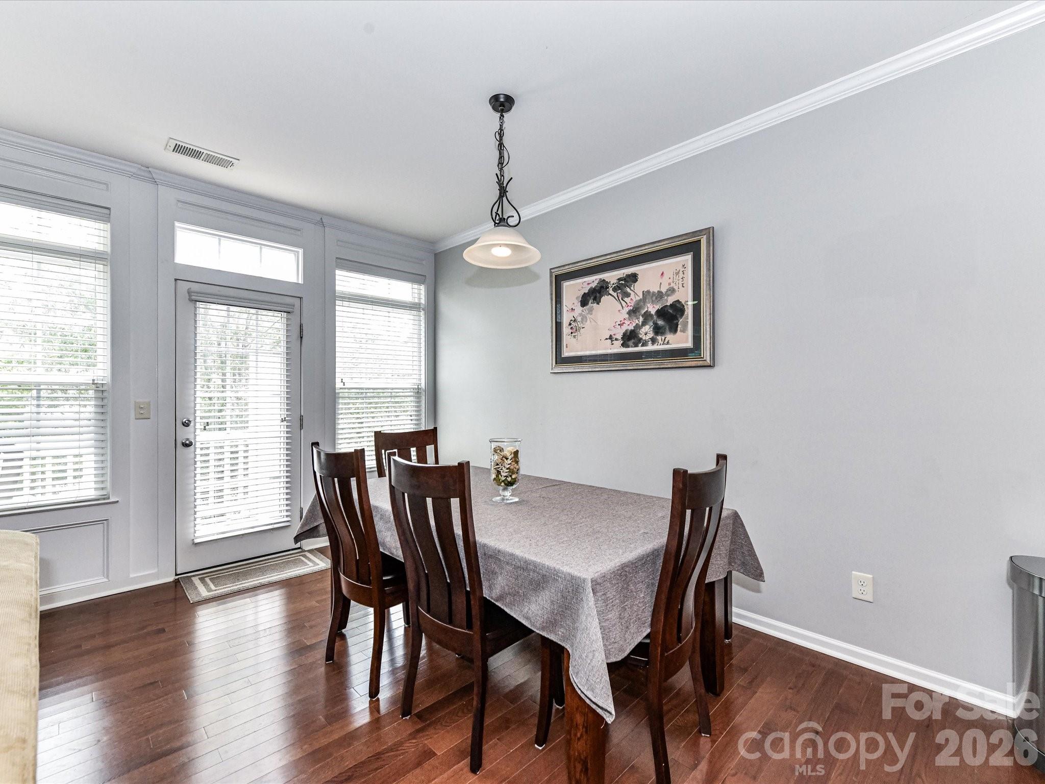 756 Naramore Street Davidson, NC 28036 - Photo 23 of 44 a view of a dining room with furniture wooden floor and a chandelier