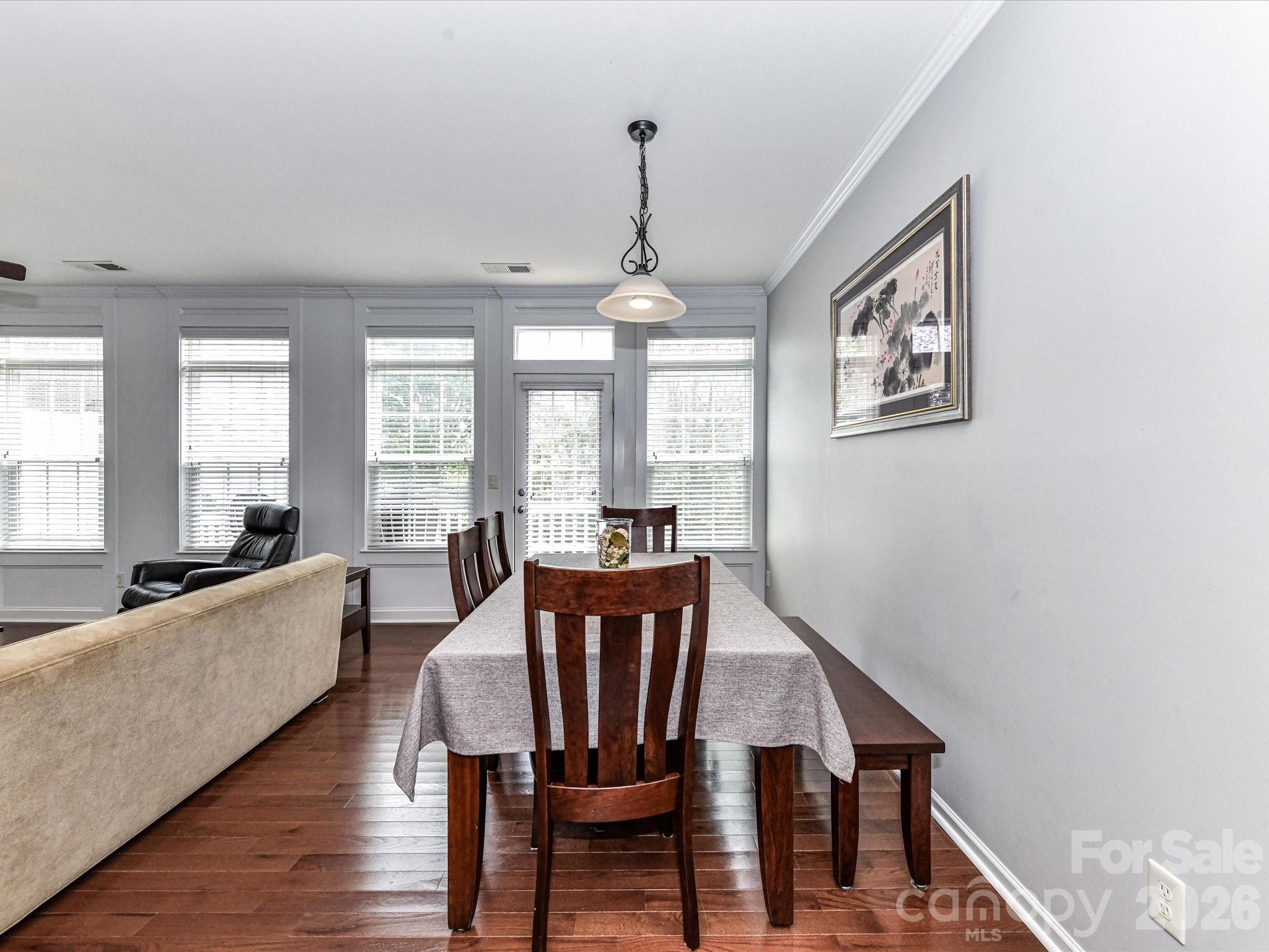 756 Naramore Street Davidson, NC 28036 - Photo 25 of 44 a view of a dining room with furniture window and wooden floor