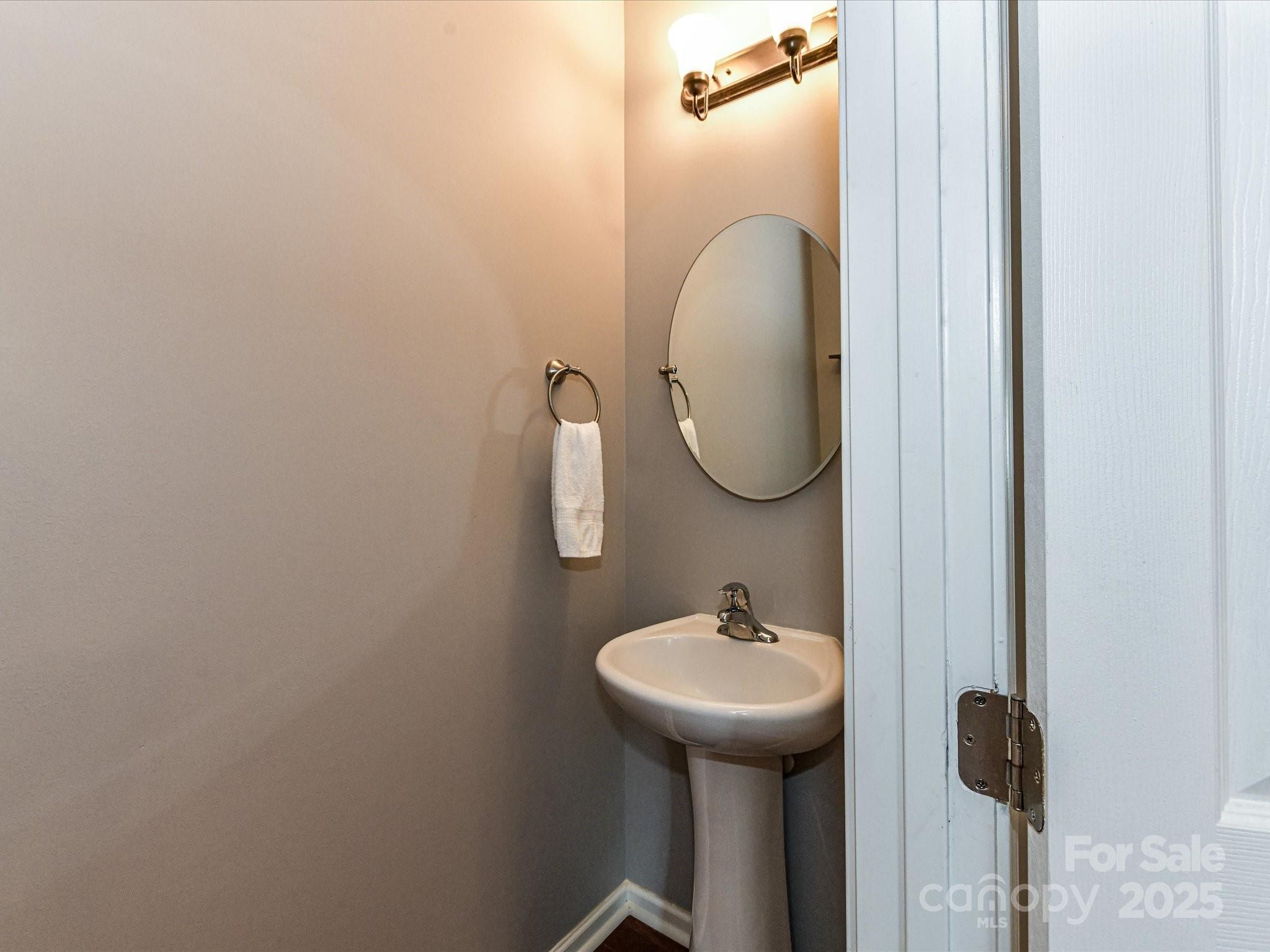 756 Naramore Street Davidson, NC 28036 - Photo 27 of 46 a bathroom with a sink and mirror