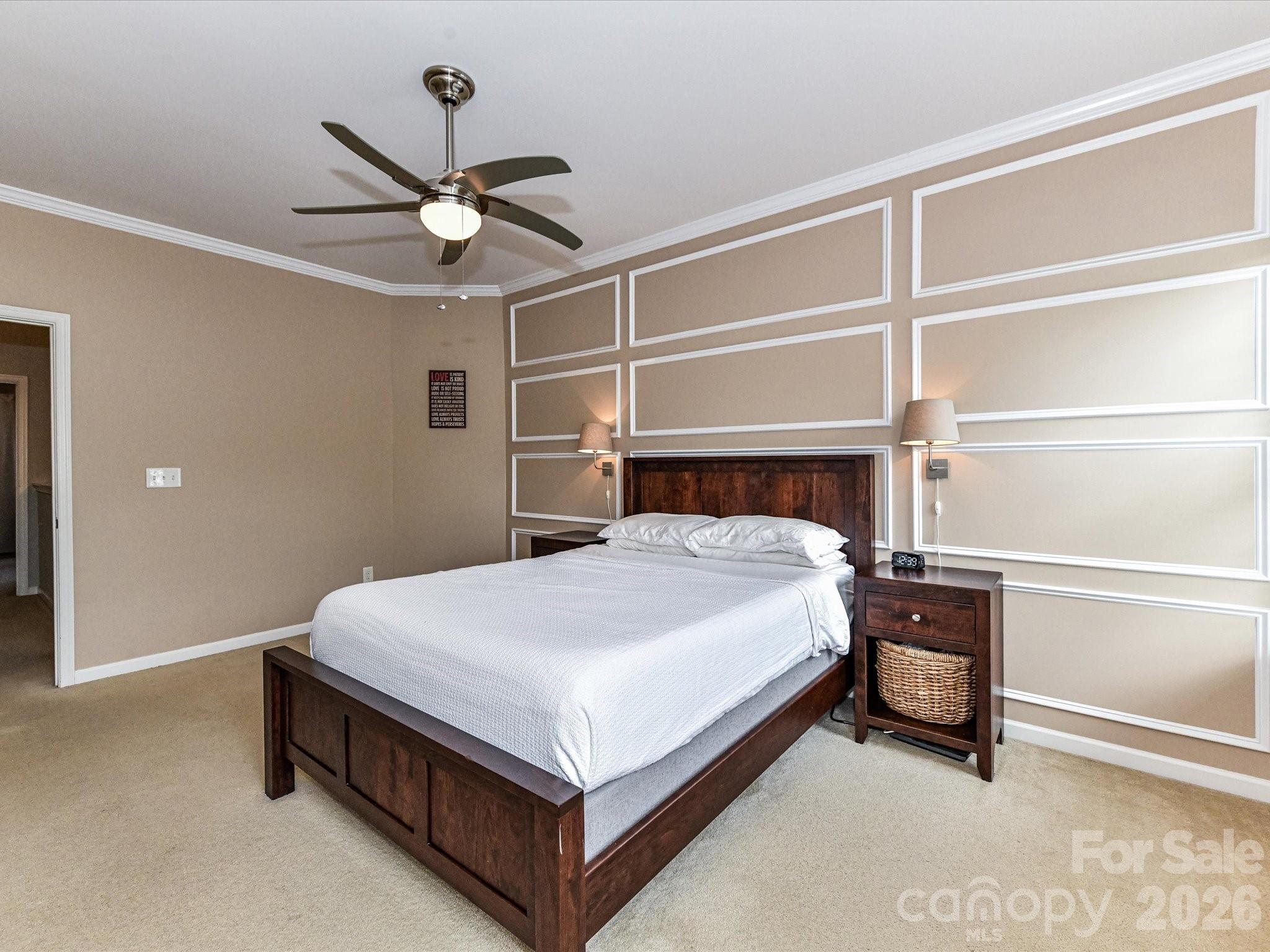 756 Naramore Street Davidson, NC 28036 - Photo 30 of 44 a bedroom with a bed and a ceiling fan