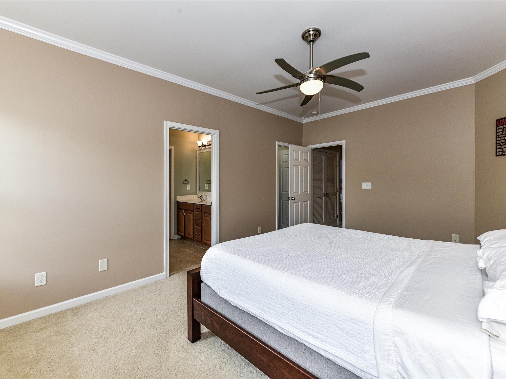 756 Naramore Street Davidson, NC 28036 - Photo 32 of 46 a bedroom with a bed and a chandelier