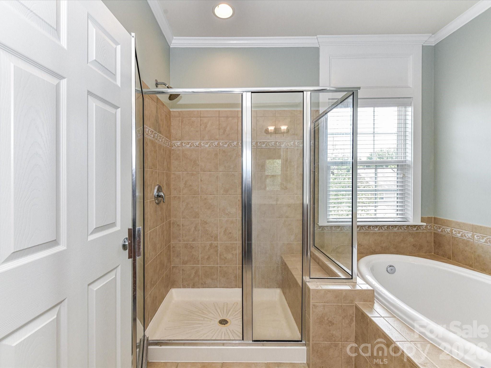 756 Naramore Street Davidson, NC 28036 - Photo 33 of 44 a bathroom with a bathtub and a shower