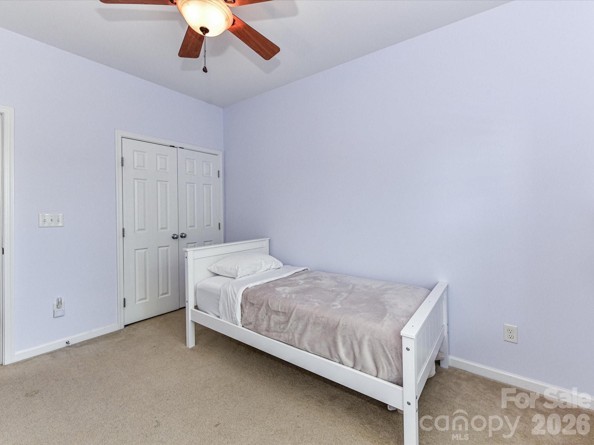 756 Naramore Street Davidson, NC 28036 - Photo 40 of 44 a bed room with a bed and a ceiling fan