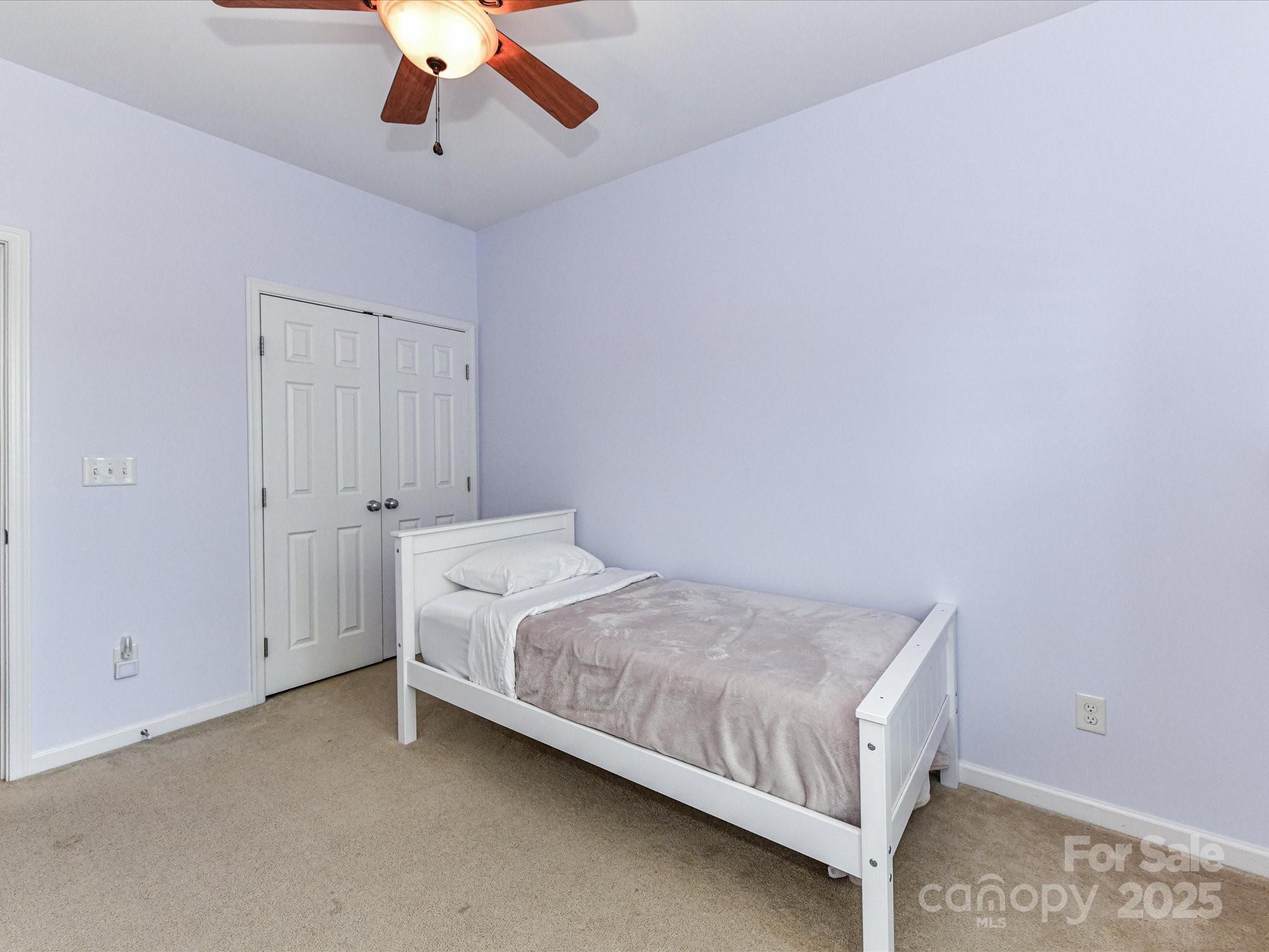 756 Naramore Street Davidson, NC 28036 - Photo 41 of 46 a bed room with a bed and a ceiling fan