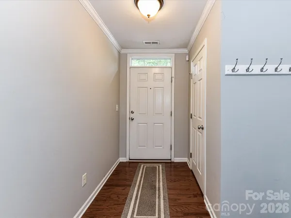 a view of a hallway with windows and wooden floor