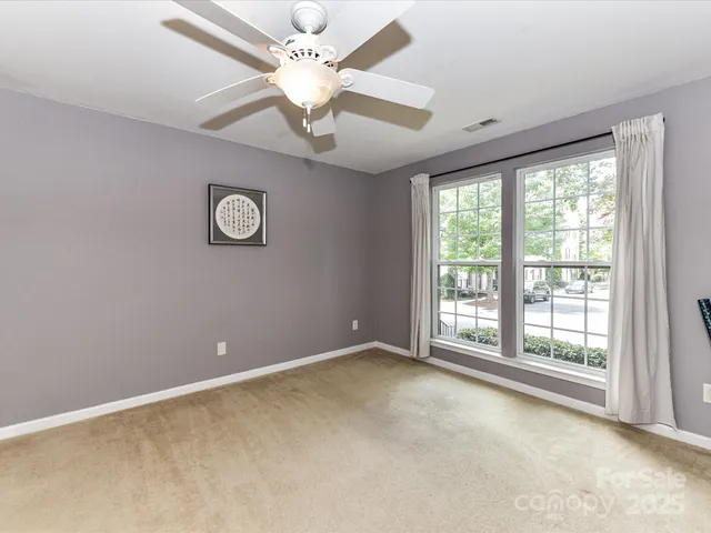 a view of empty room with ceiling fan