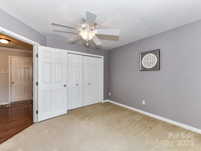 a room with a chandelier and wooden floor