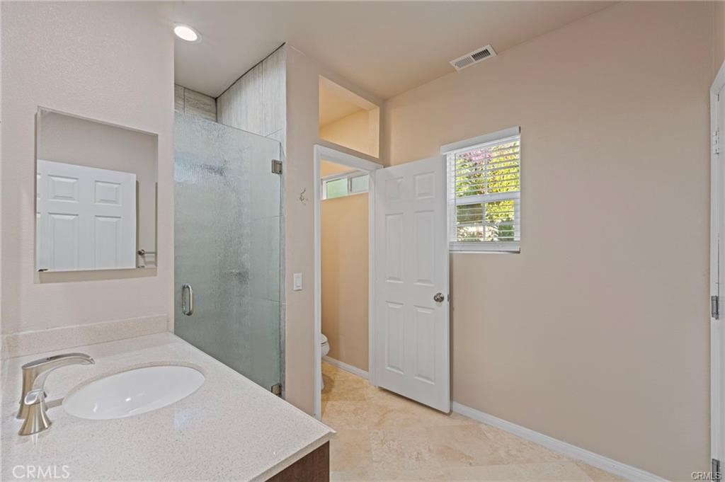 8634 Hunt Canyon Road Corona, CA 92883 - Photo 12 of 31 a bathroom with a sink a toilet and shower
