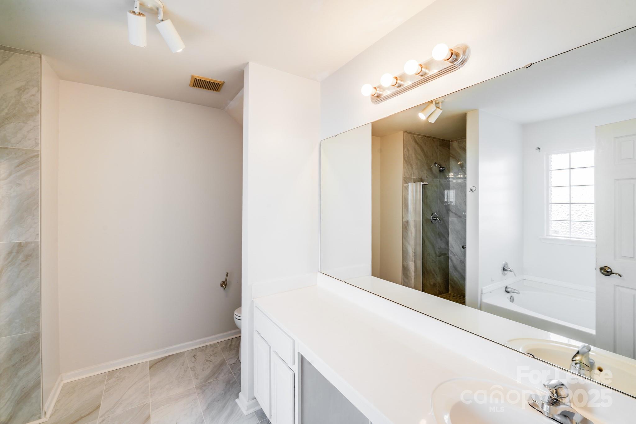 1427 Jabbok Place Northwest Concord, NC 28027 - Photo 19 of 30 a bathroom with a bathtub and a sink