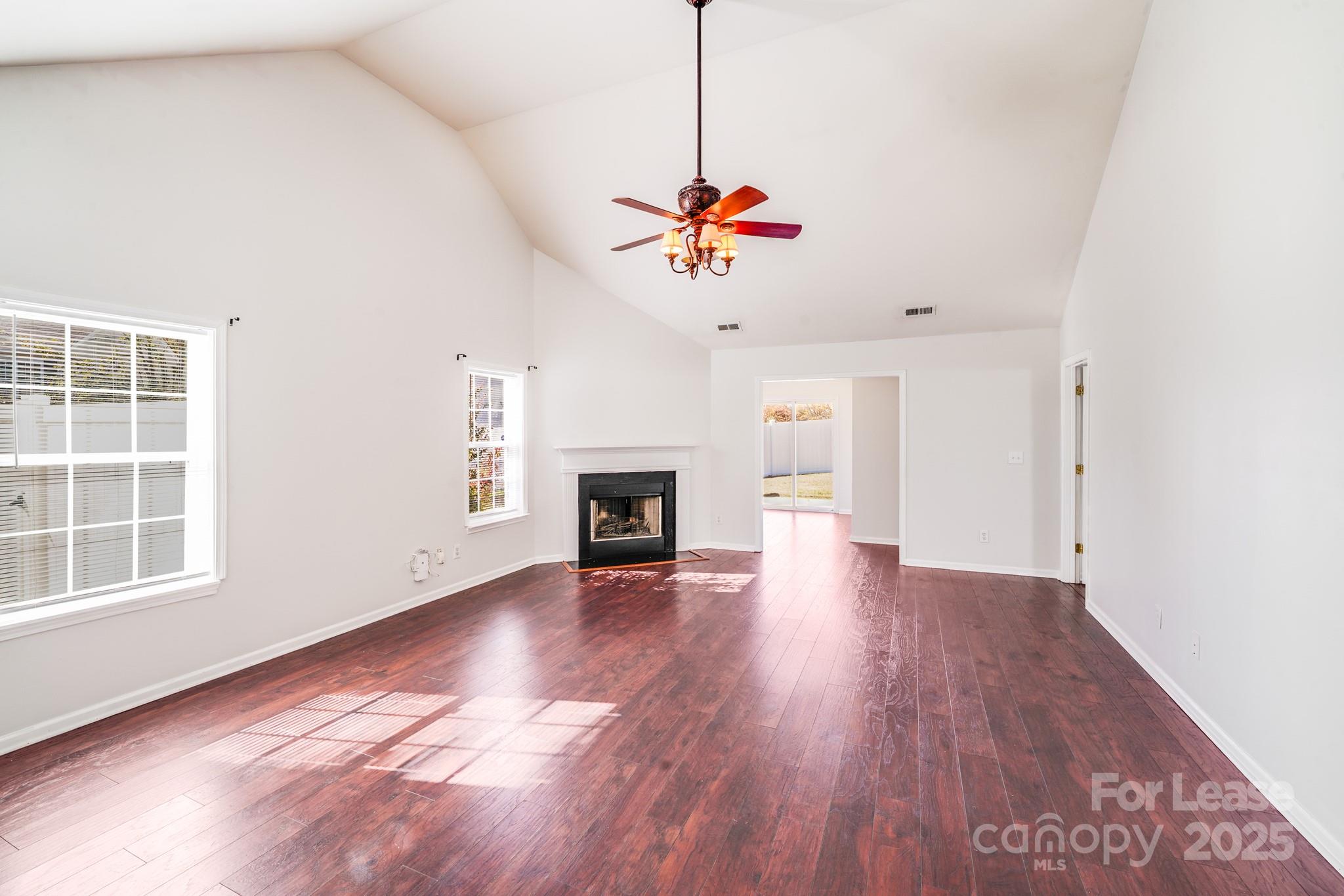 1427 Jabbok Place Northwest Concord, NC 28027 - Photo 2 of 30 a view of an empty room with wooden floor and a window