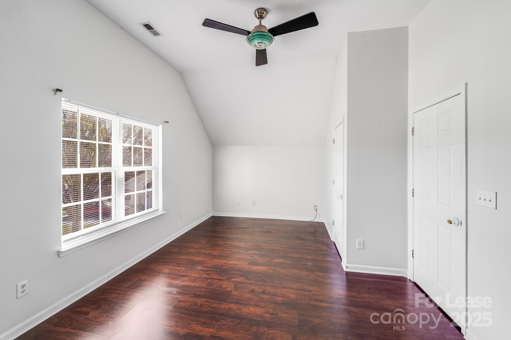 1427 Jabbok Place Northwest Concord, NC 28027 - Photo 22 of 30 a view of empty room with wooden floor and fan