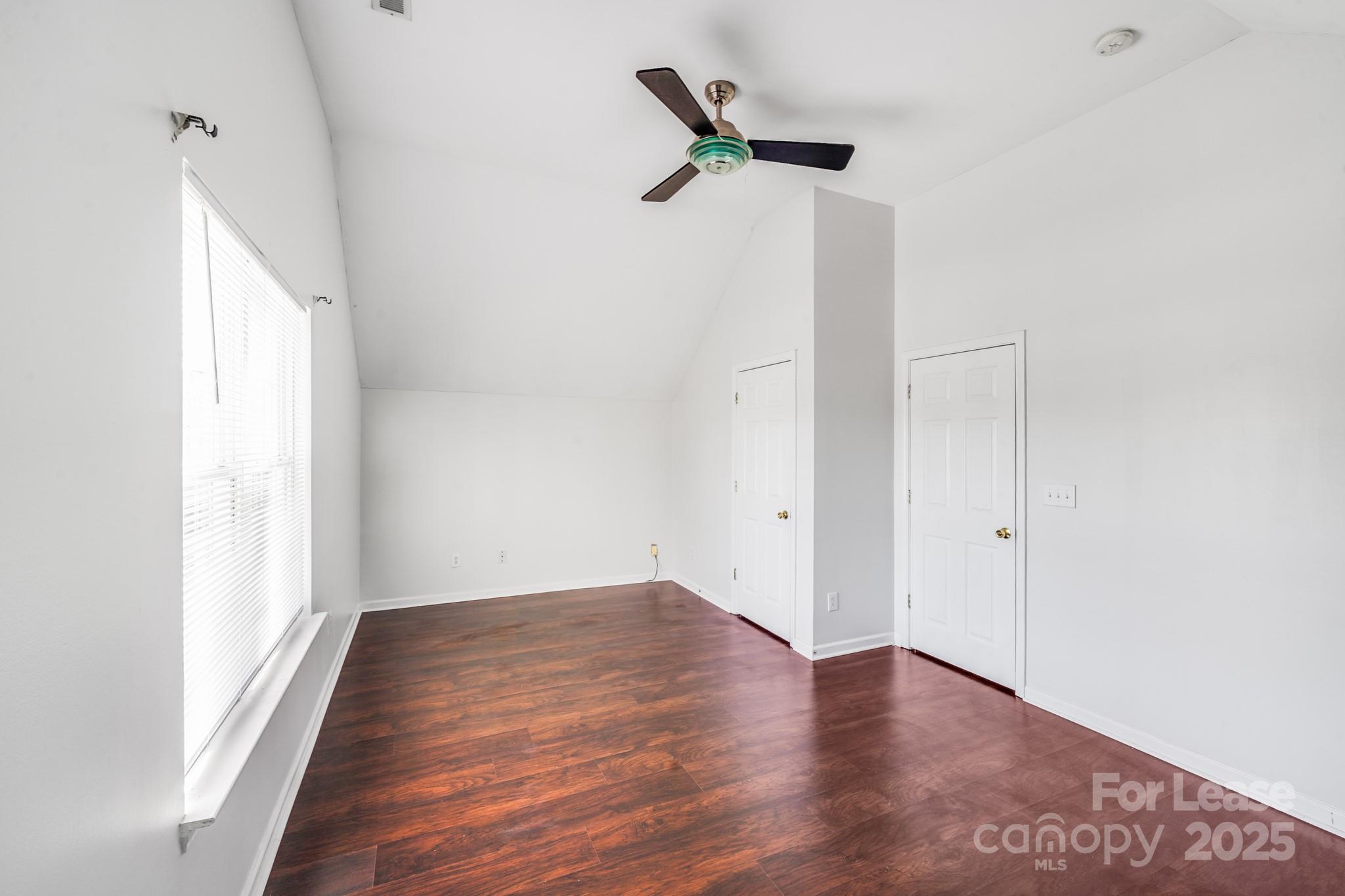 1427 Jabbok Place Northwest Concord, NC 28027 - Photo 23 of 30 a view of a room with wooden floor and a ceiling fan