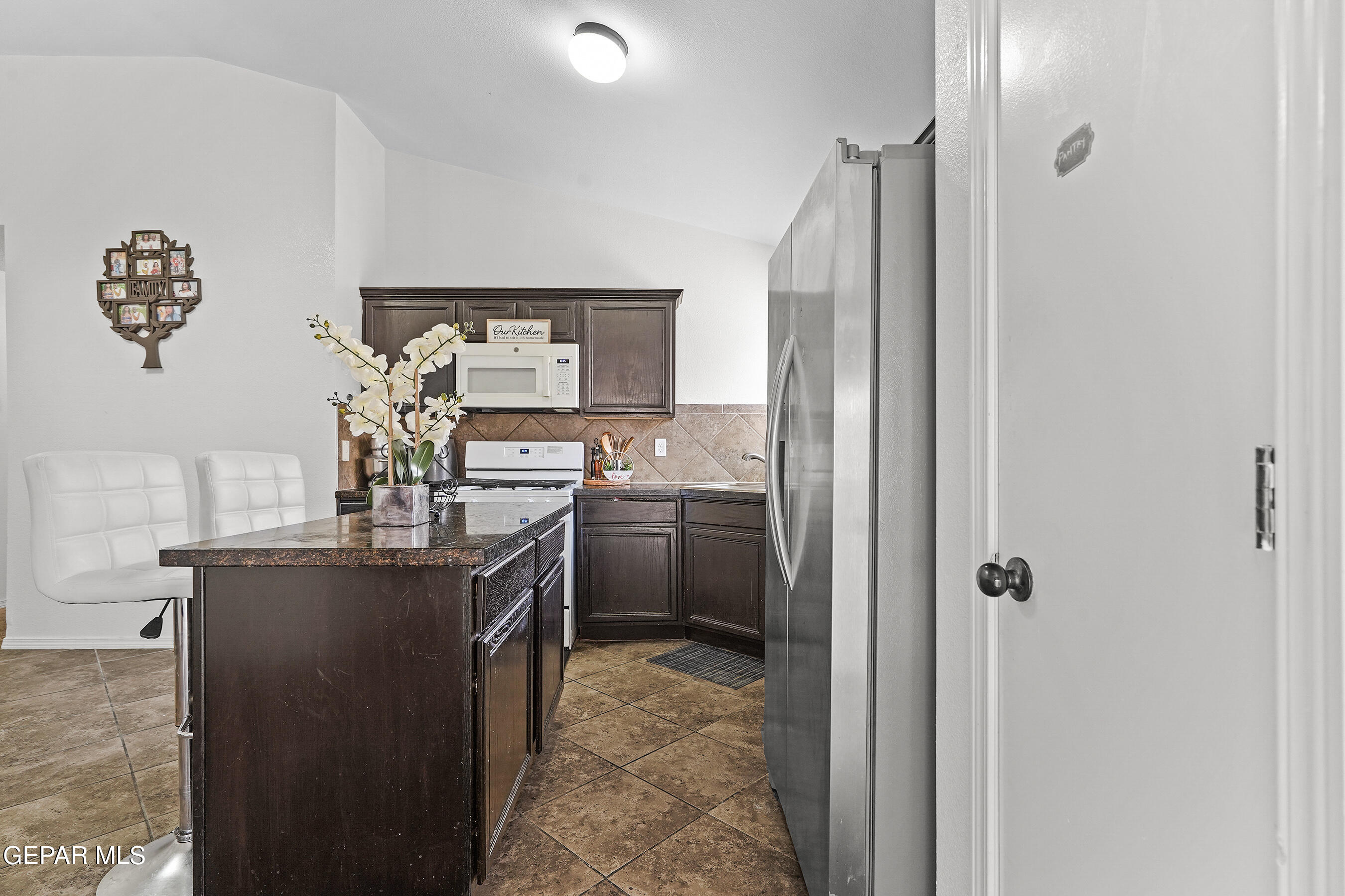12733 Raul Mendiola Lane El Paso, TX 79938 - Photo 15 of 30 a kitchen with stainless steel appliances granite countertop a refrigerator and a sink