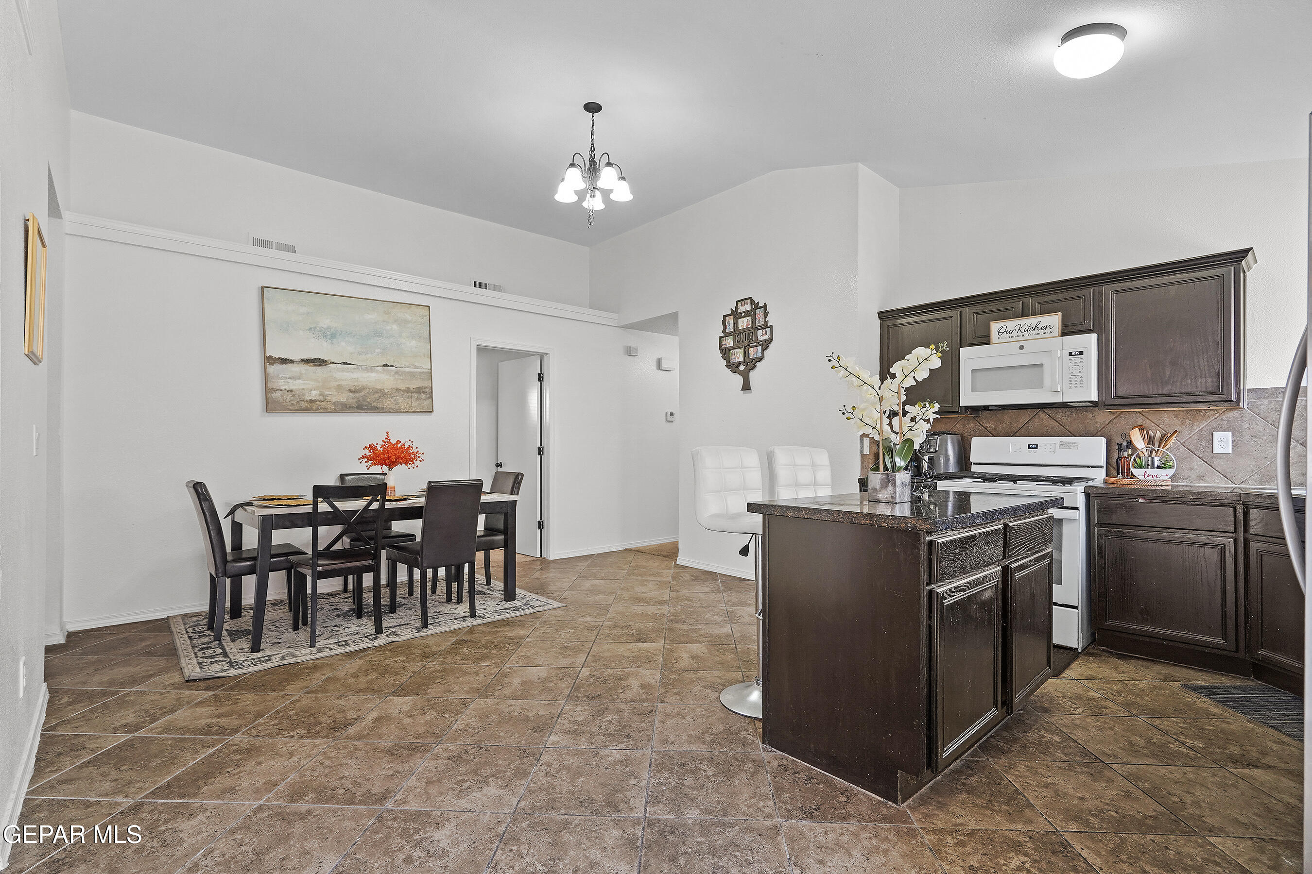12733 Raul Mendiola Lane El Paso, TX 79938 - Photo 16 of 30 a kitchen with cabinets and chairs