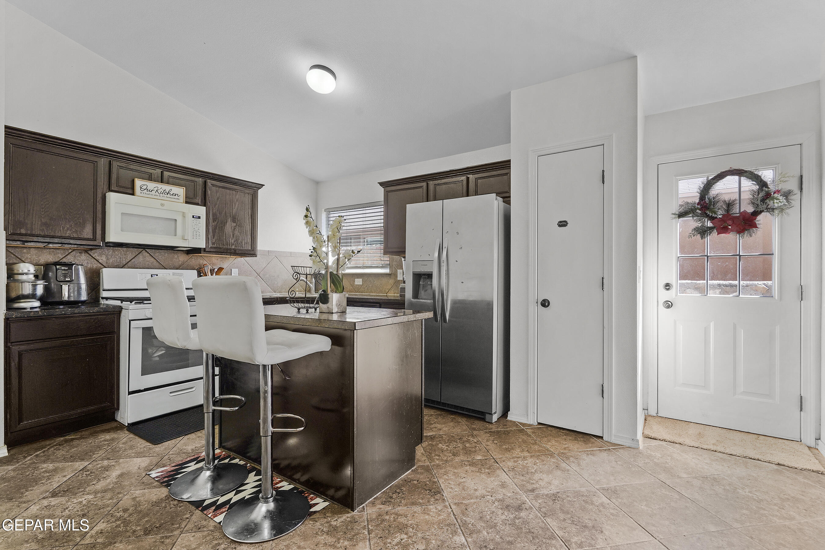 12733 Raul Mendiola Lane El Paso, TX 79938 - Photo 17 of 30 a kitchen with stainless steel appliances granite countertop a refrigerator and a stove top oven