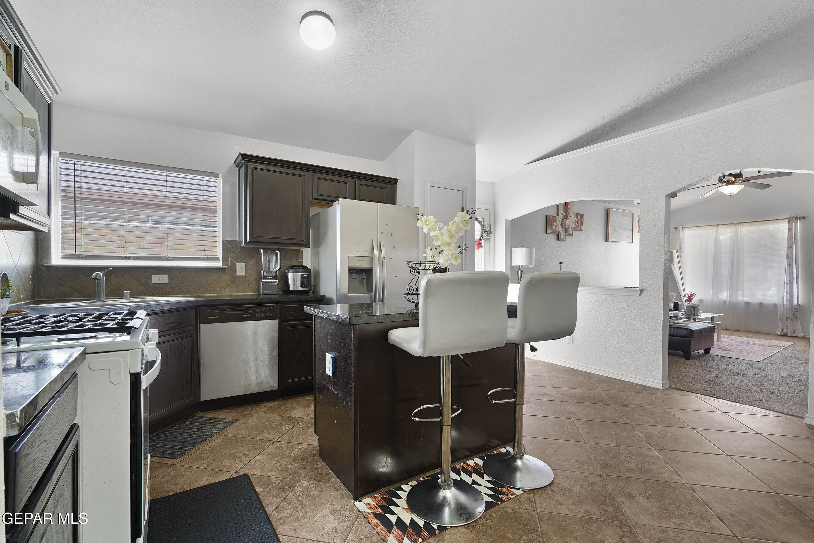 12733 Raul Mendiola Lane El Paso, TX 79938 - Photo 18 of 30 a kitchen with a sink stove and refrigerator