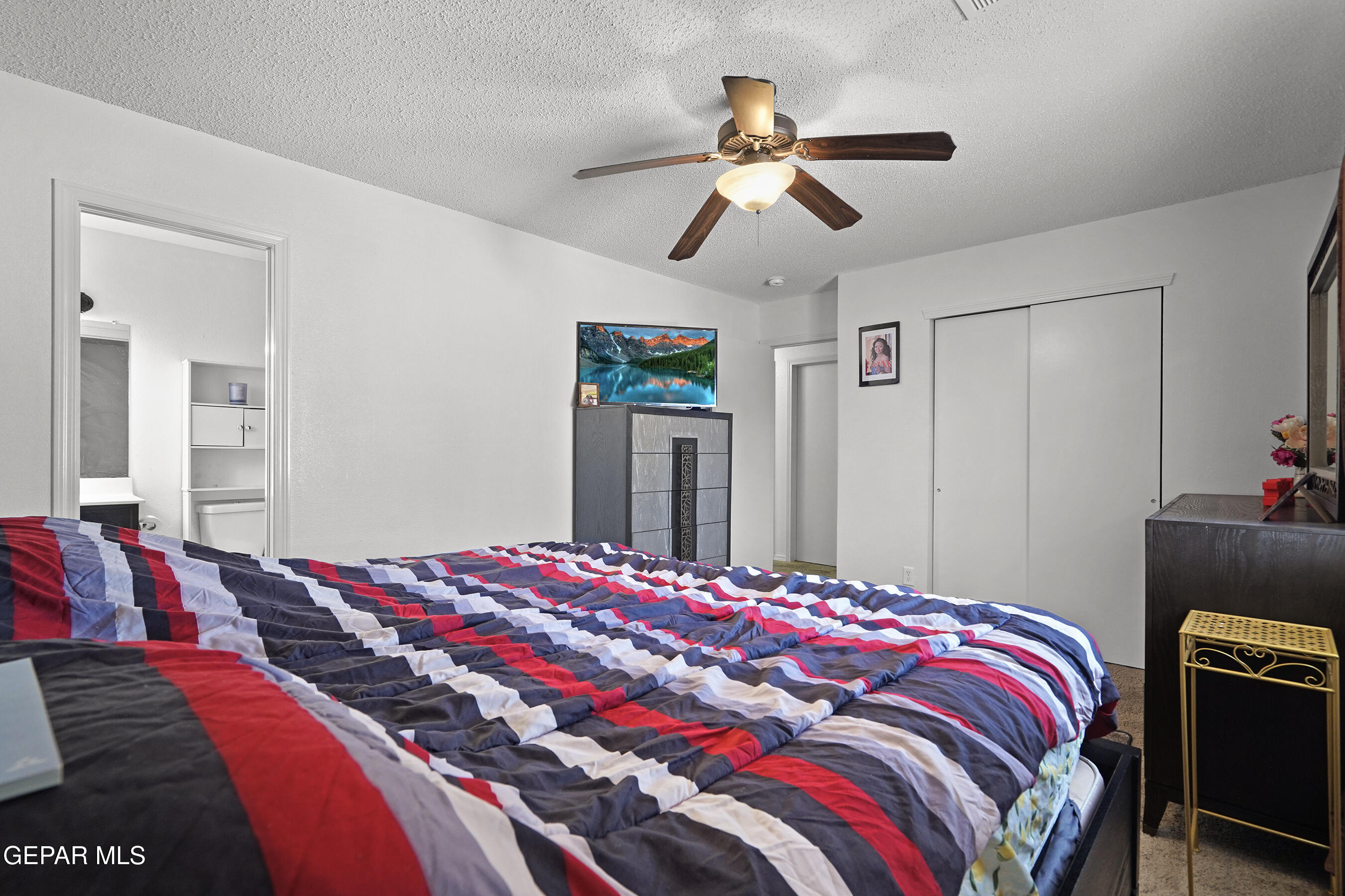 12733 Raul Mendiola Lane El Paso, TX 79938 - Photo 23 of 30 a bedroom with a bed and a chandelier