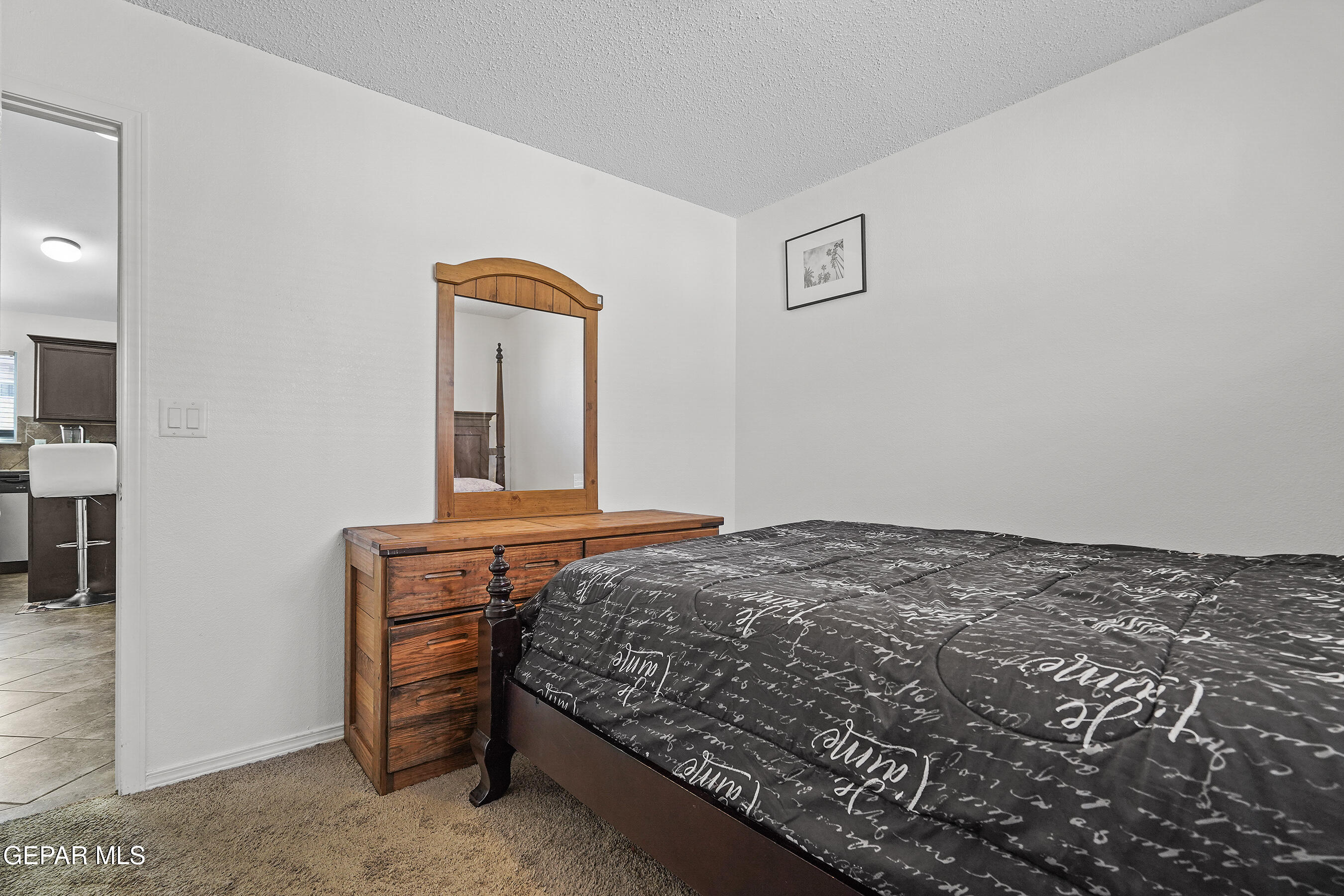 12733 Raul Mendiola Lane El Paso, TX 79938 - Photo 6 of 30 a bedroom with a bed and a lamp on table