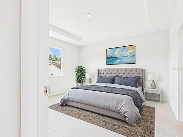 a bedroom with a bed and painting on the wall