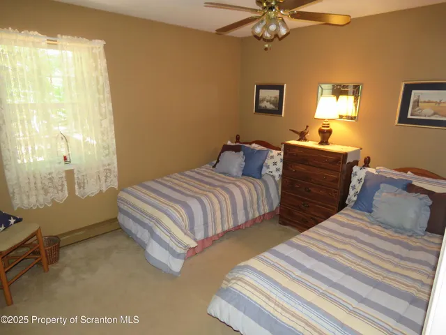 a bedroom with two beds and painted walls