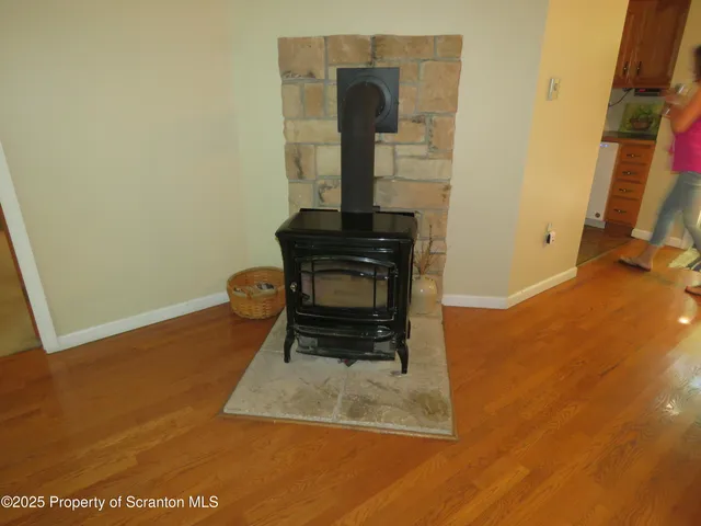a living room with a furniture and a fireplace