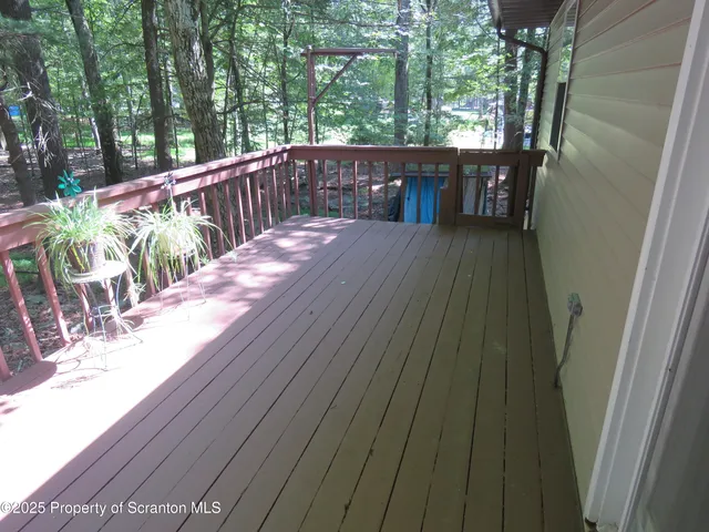 a view of balcony with wooden floor and outdoor seating