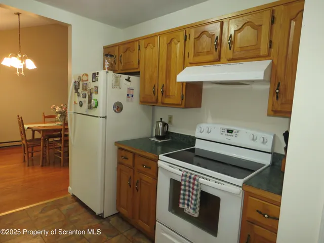 a kitchen with a stove and a refrigerator