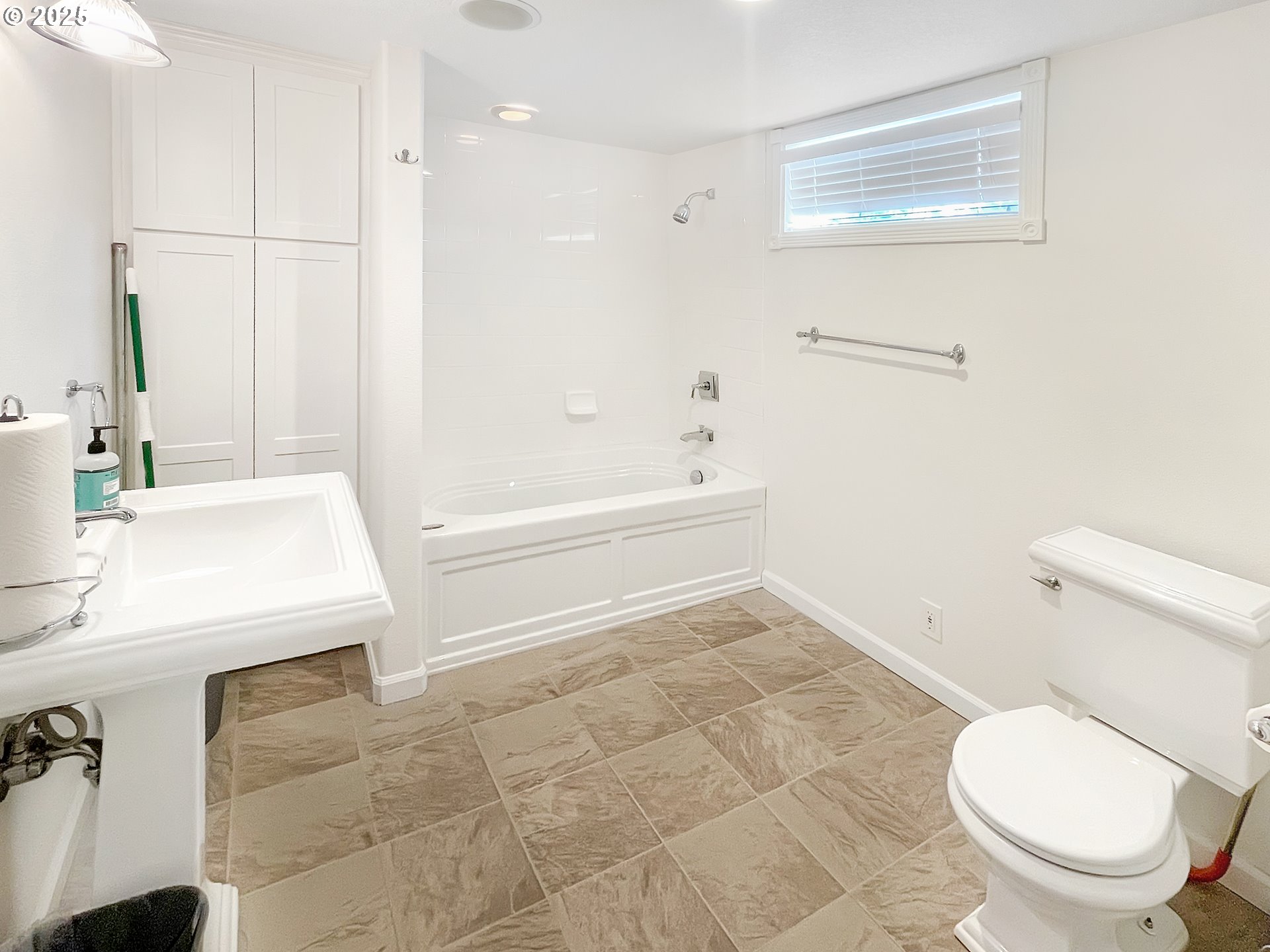 4535 Southwest Laurelwood Avenue Portland, OR 97225 - Photo 5 of 10 a bathroom with a sink a toilet a vanity and mirror