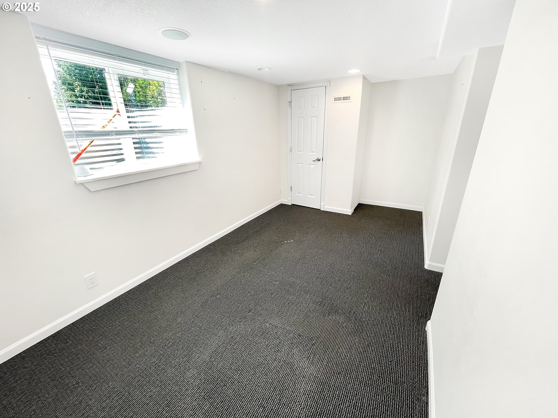 4535 Southwest Laurelwood Avenue Portland, OR 97225 - Photo 7 of 10 an empty room with windows