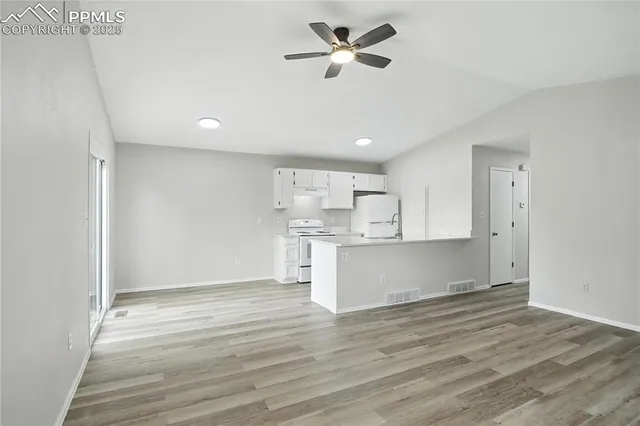 a view of kitchen with wooden floor and window
