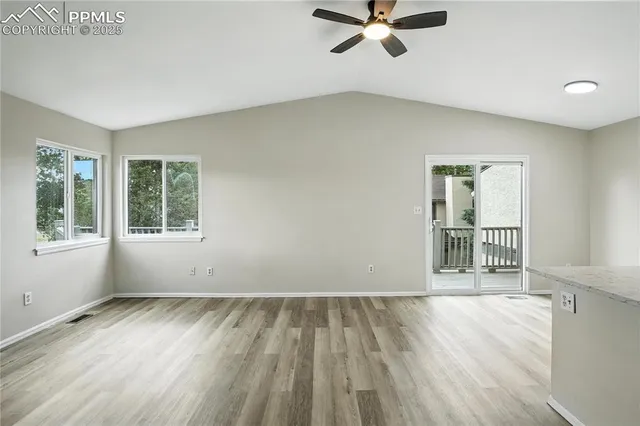 a view of wooden floor and windows in a room