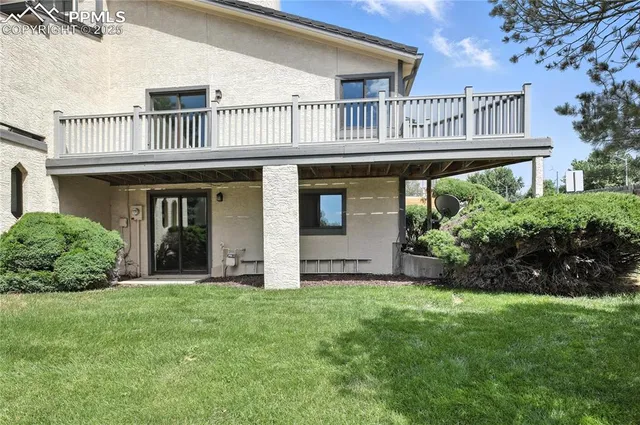 a view of backyard of house with green space