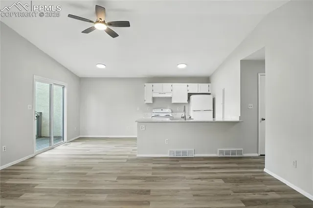 a view of kitchen with wooden floor and window