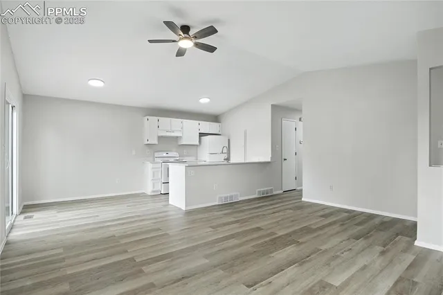 a view of kitchen with wooden floor and window
