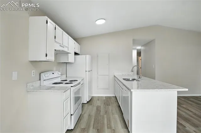 a kitchen with stainless steel appliances granite countertop a sink stove and cabinets