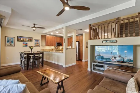 a kitchen with stainless steel appliances kitchen island granite countertop furniture and a dining table