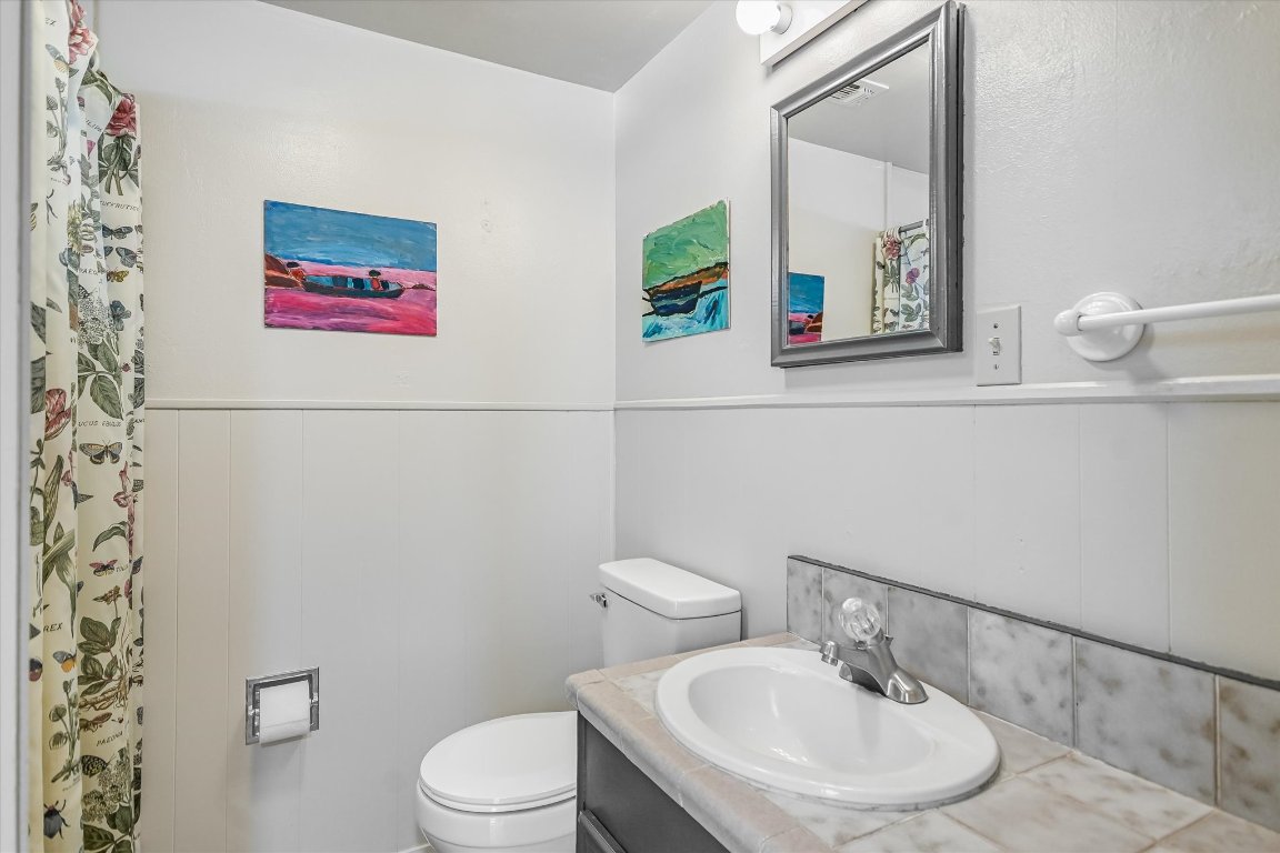 175 Fischer Trail Wimberley, TX 78676 - Photo 13 of 33 a bathroom with a toilet sink and mirror