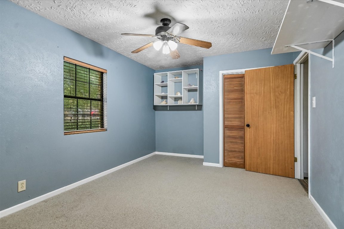 175 Fischer Trail Wimberley, TX 78676 - Photo 14 of 33 an empty room with windows and fan