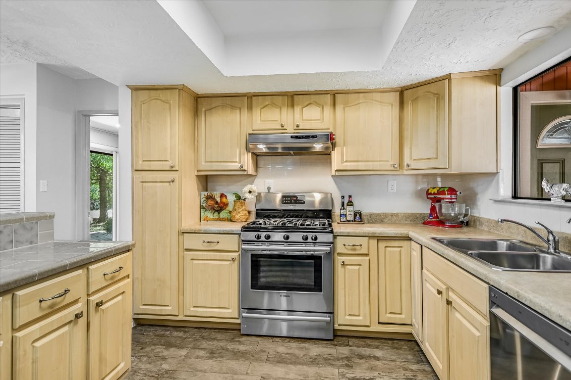 175 Fischer Trail Wimberley, TX 78676 - Photo 9 of 33 a kitchen with granite countertop a stove a sink and a granite counter tops