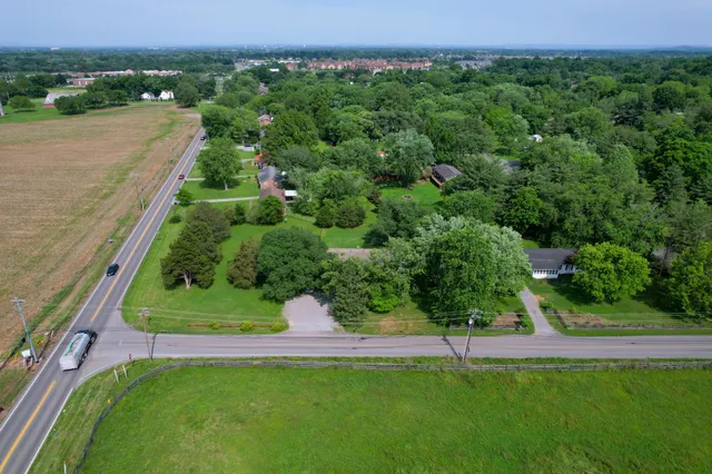 a view of a garden with a building in the background